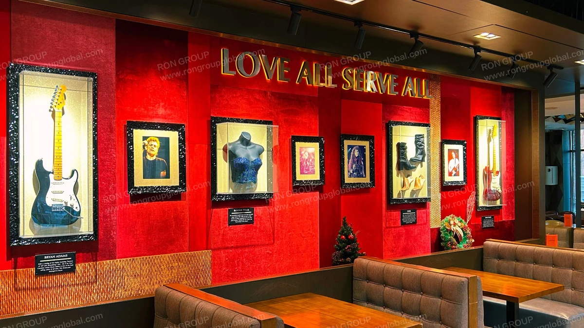 Hard Rock Cafe custom tufted banquettes and solid wood tables integrated with memorabilia millwork by Ron Group