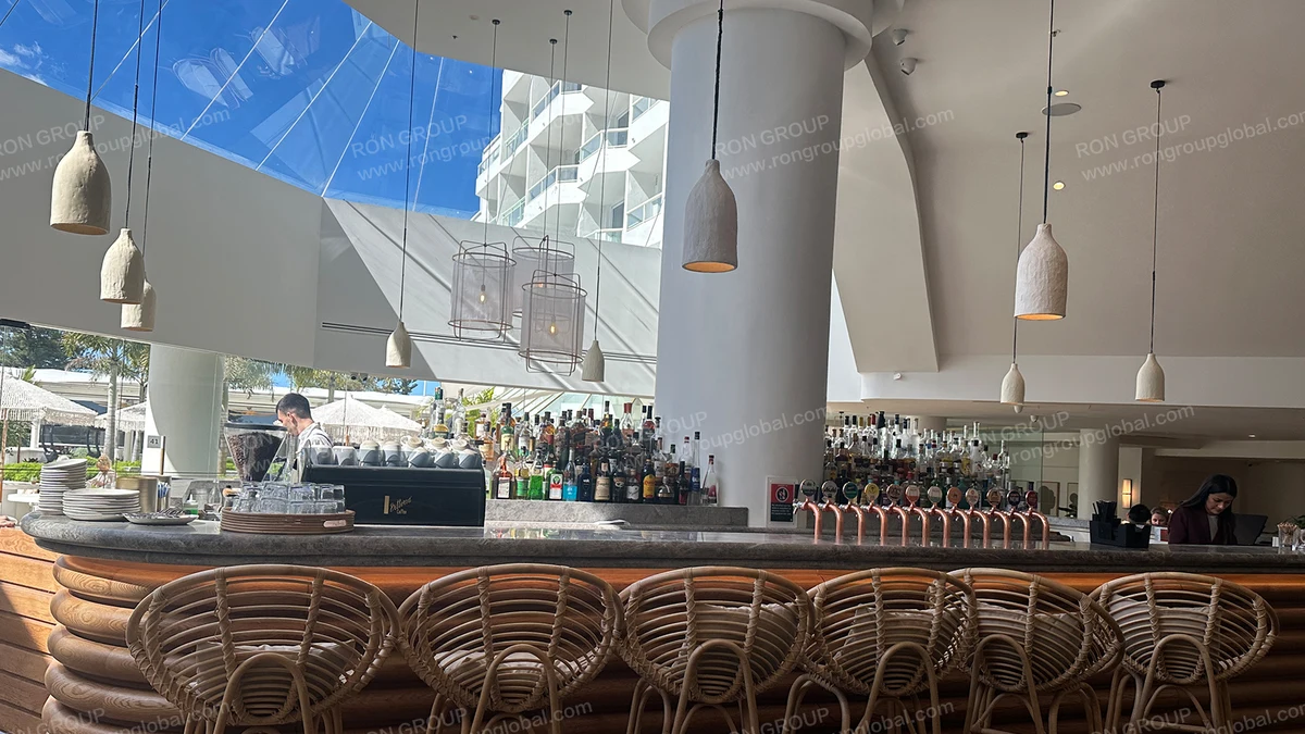 Novotel Sydney Brighton Beach custom fluted timber bar counter and rattan dining seating by Ron Group