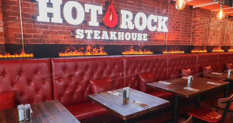 Hot Rock Steakhouse interior reference: Red leather look · Brick & timber