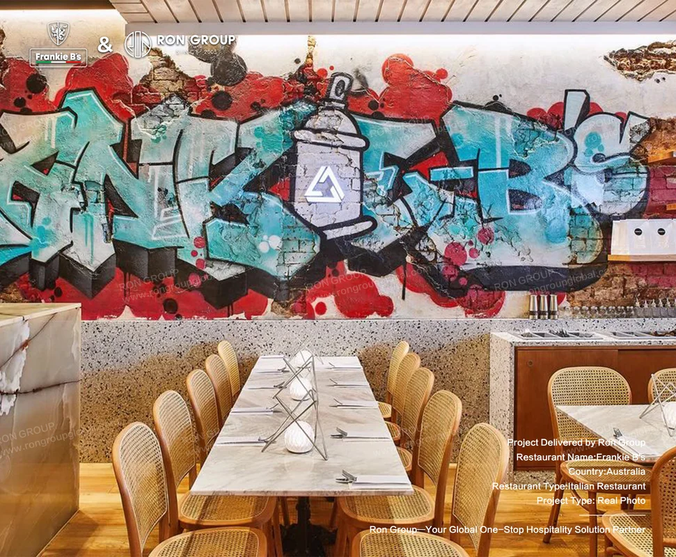 Graffiti-covered dining wall at Frankie B's with custom rattan seating
