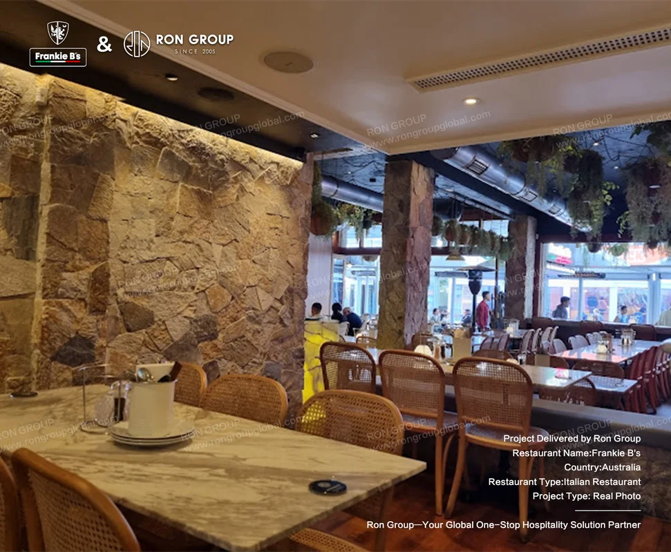 Stone wall interior at Frankie B's with custom furniture arrangement