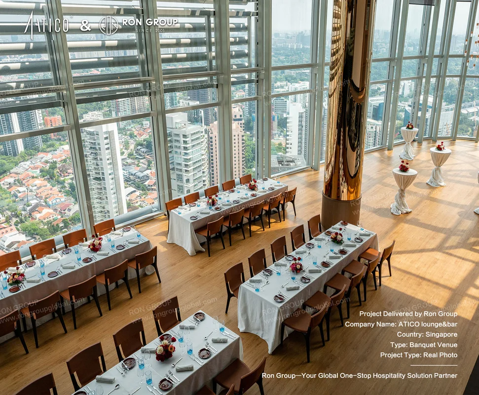ATICO highrise banquet hall with city view long tables white linens floral centerpieces and wooden chairs