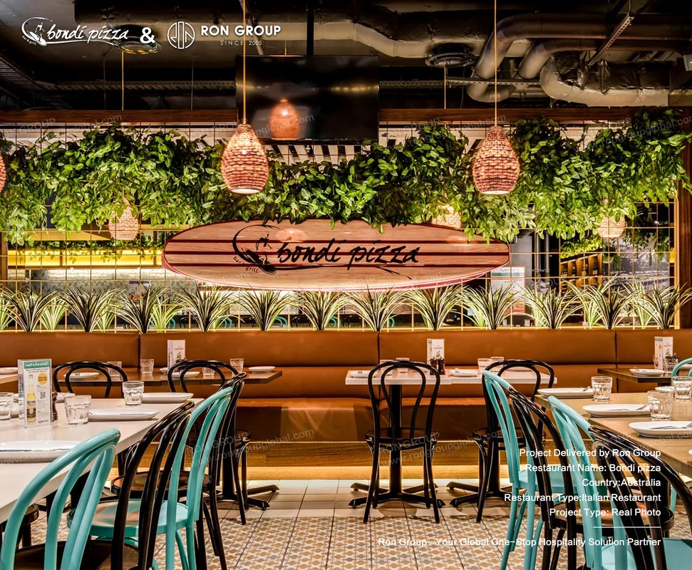 Bondi Pizza green chairs plant wall and booth seating