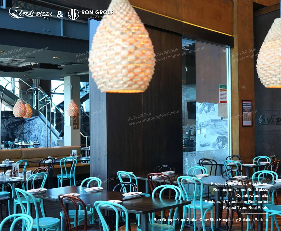 Bondi Pizza green chairs round tables and open kitchen view