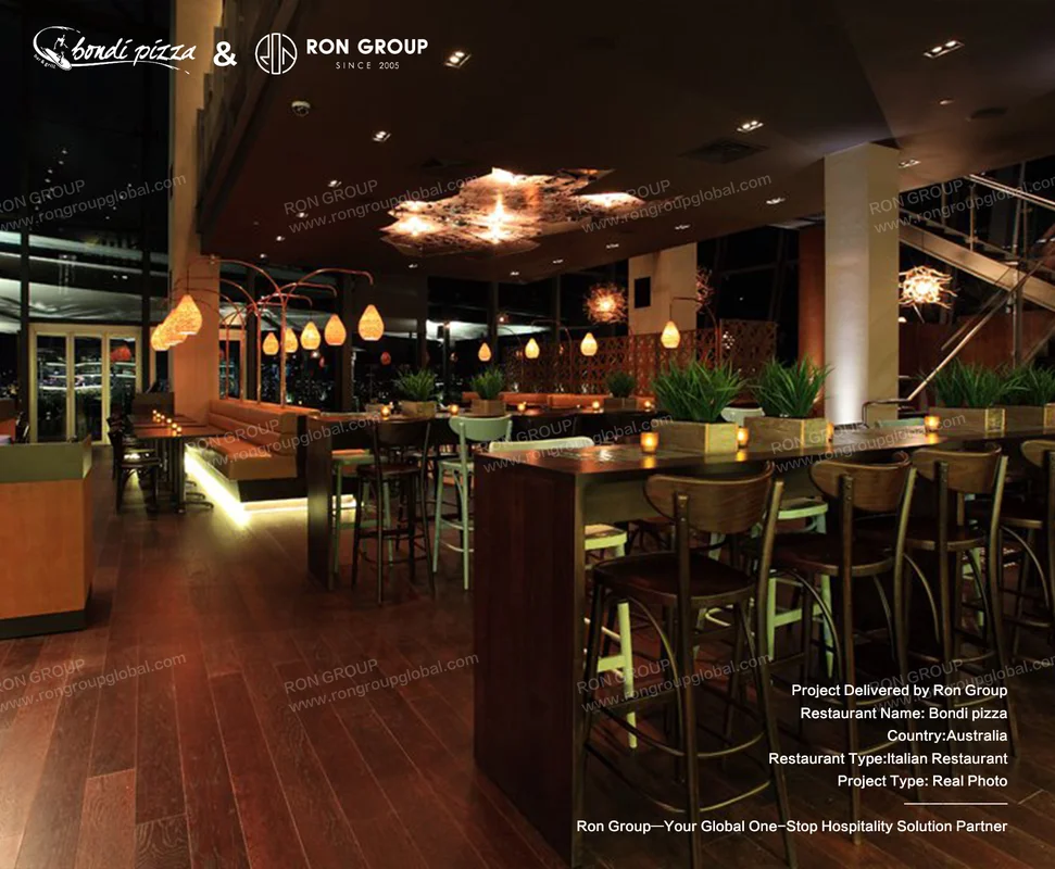 Bondi Pizza open dining room with round tables and pendant lights