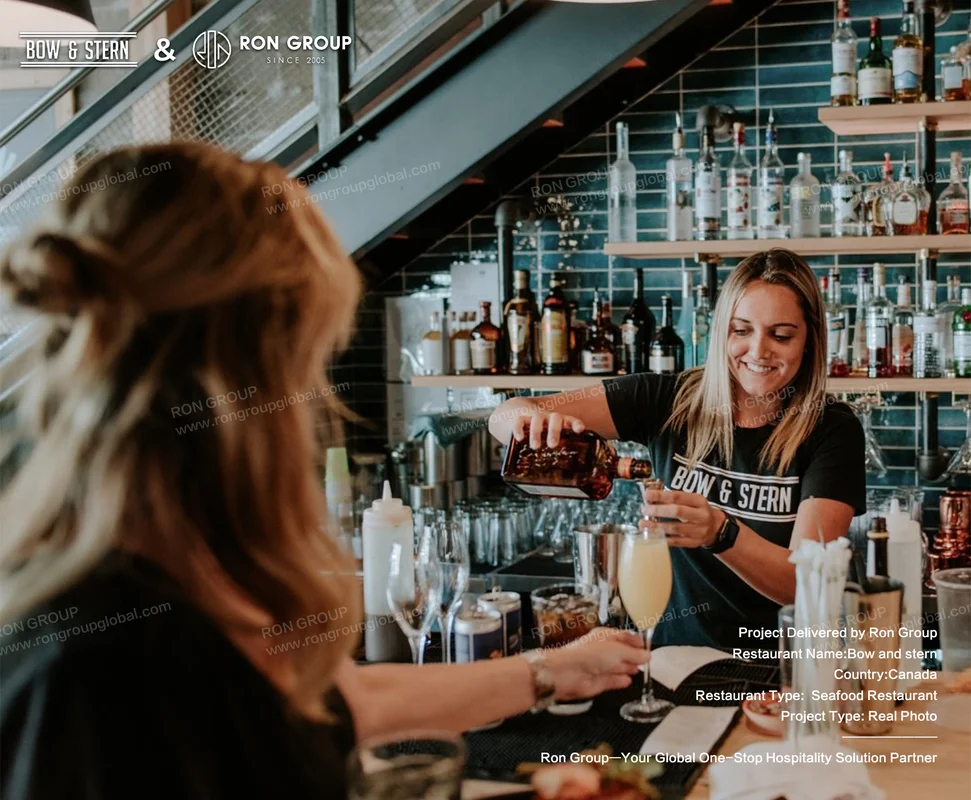 Bow and Stern bartender pouring drink at bar