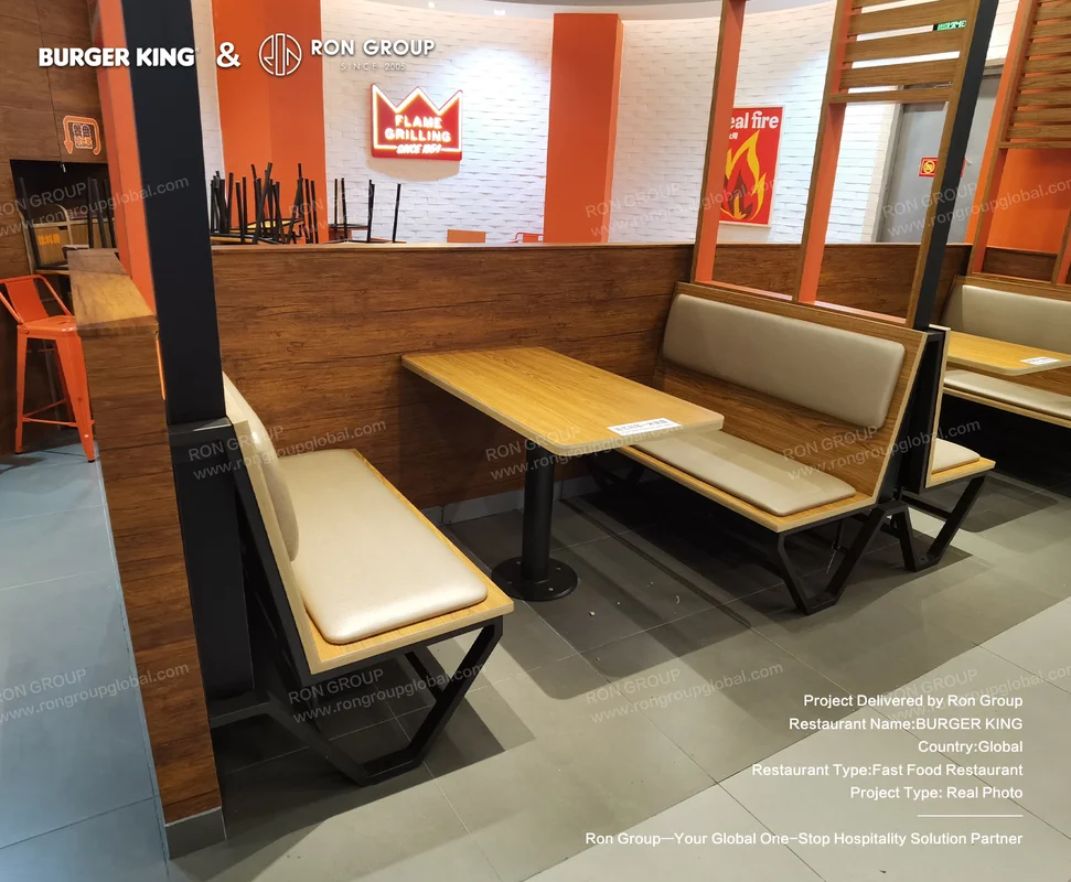 Burger King booth seating with wooden table and orange accents