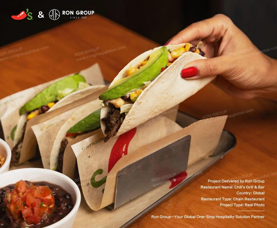 Chili's Grill & Bar hand holding taco with avocado