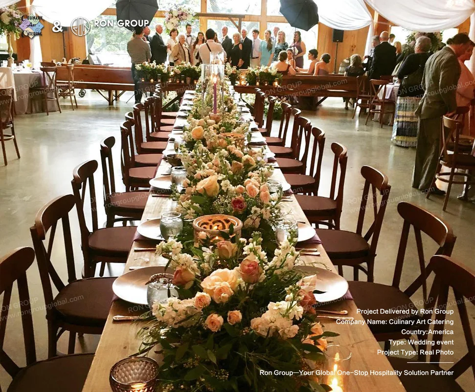 Culinary Art Catering long wooden table with floral centerpieces