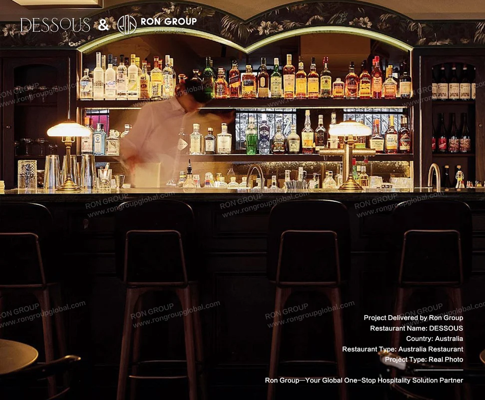 DESSOUS bar interior with liquor shelves and dark stools