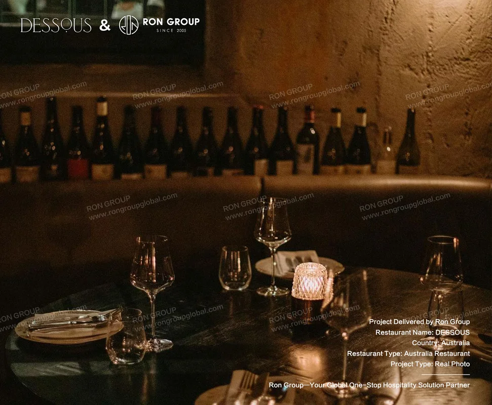 Candlelit dining table with wine display backdrop