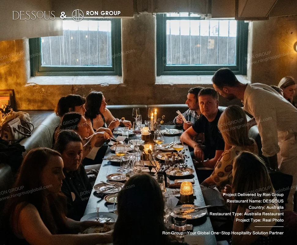 Group dining at a long table in DESSOUS