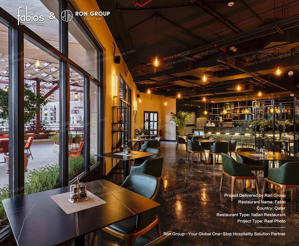 Fabio modern Italian restaurant interior with dark tables green velvet chairs pendant lights and terrace view