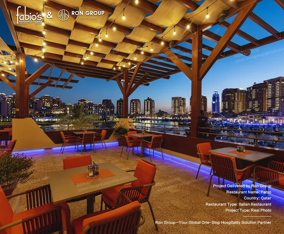 Fabio rooftop Italian restaurant terrace with pergola string lights orange seating and marina city view