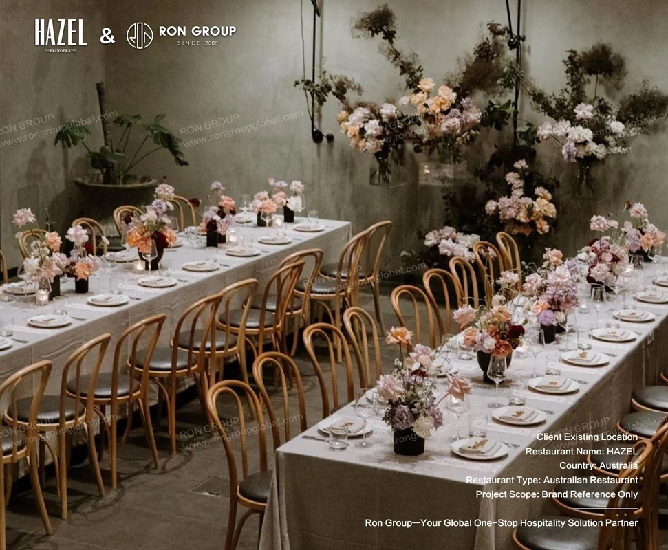 Event dining room setup with flowers and timber chairs