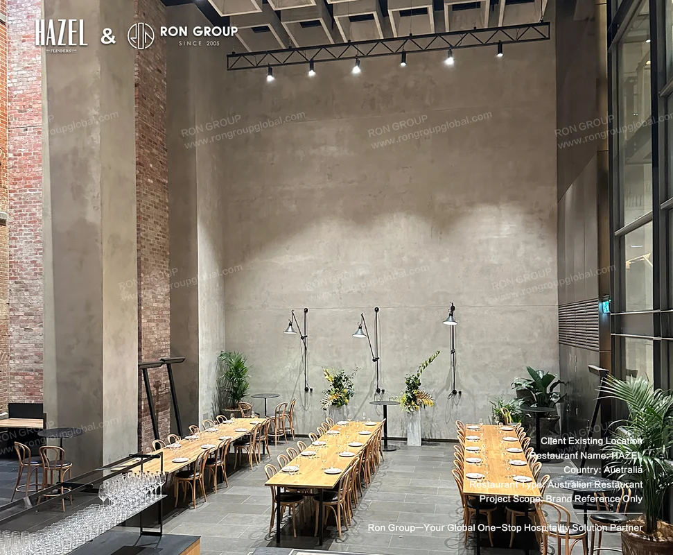 Industrial dining space with timber tables at HAZEL Restaurant