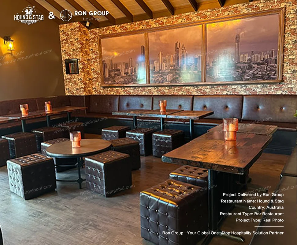 Hound Stag rustic bar restaurant interior with leather booths wood tables stools and stone wall mural
