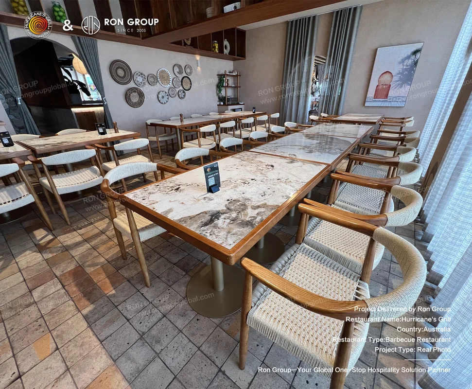 Marble-top tables with woven chairs and decorative wall plates