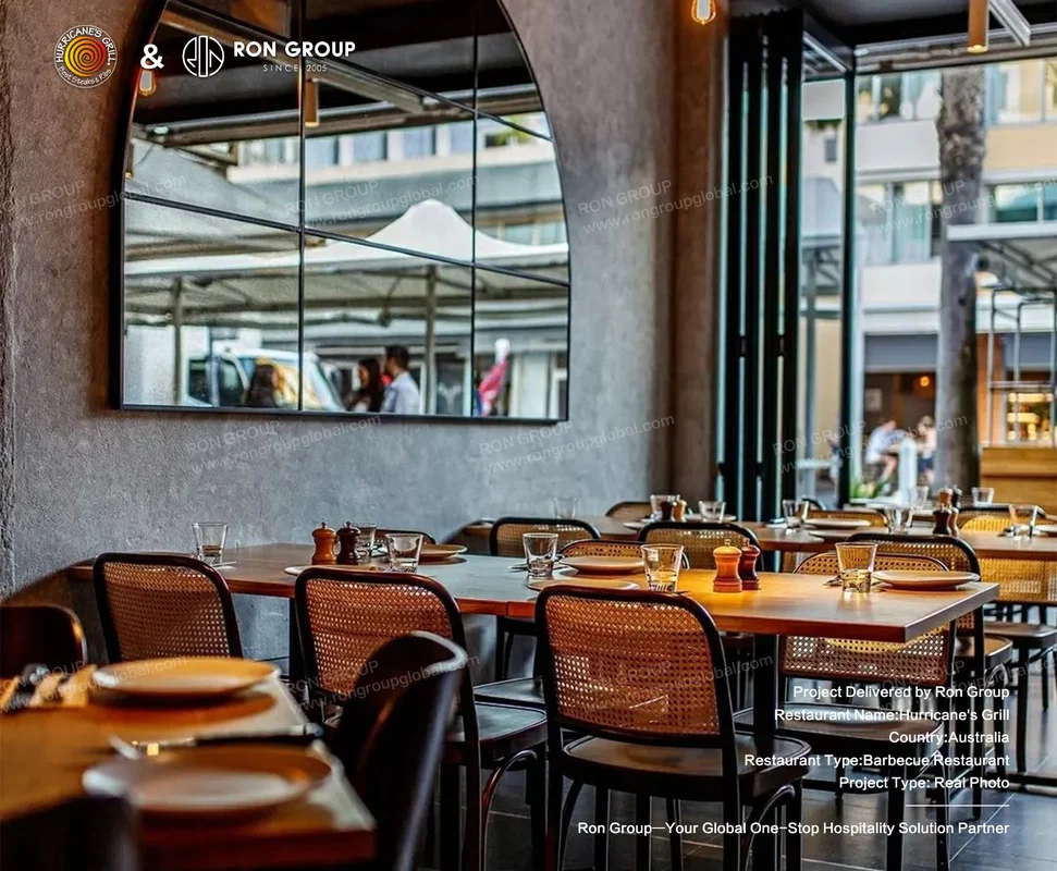 Modern steakhouse interior with wooden tables and arched mirror
