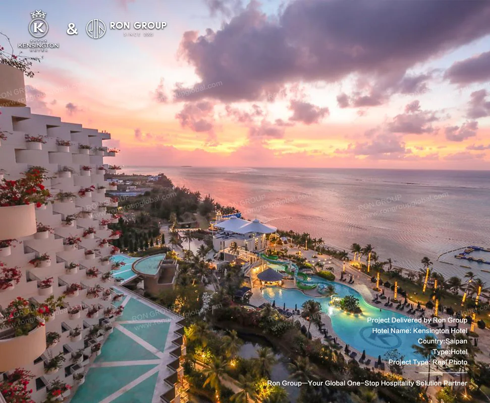 Kensington Hotel Saipan coastal resort at sunset with pools and palm trees