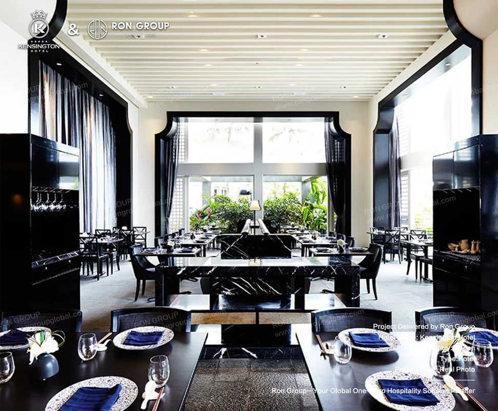 Kensington Hotel modern restaurant interior with black marble tables and dark chairs