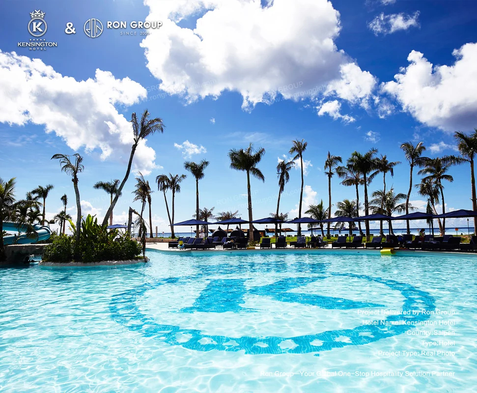 Kensington Hotel tropical pool with palm trees and blue umbrellas