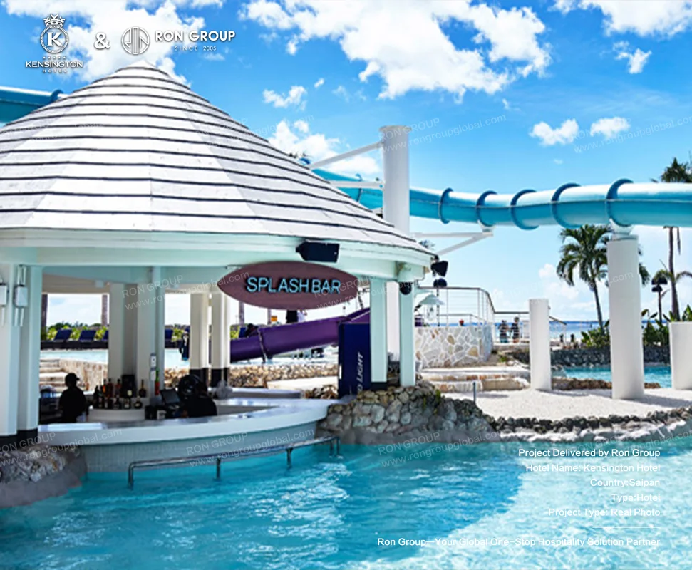 Kensington Hotel water park bar with slide and tropical pool area