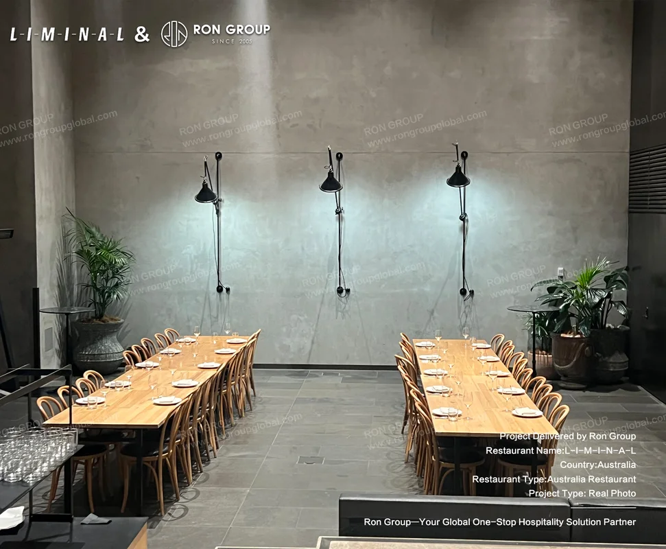 Concrete wall with long wooden dining tables