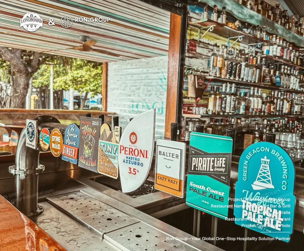 Longboard Bar & Grill RonGroup-Longboard_Bar_Grill-Beer_Taps_With_Colorful_Signs.webp