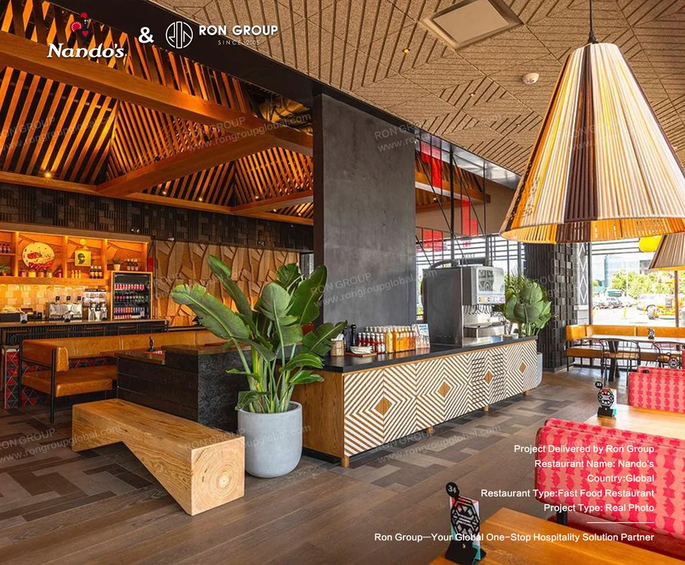 Nando's modern fast food restaurant interior with red seating and wooden ceiling