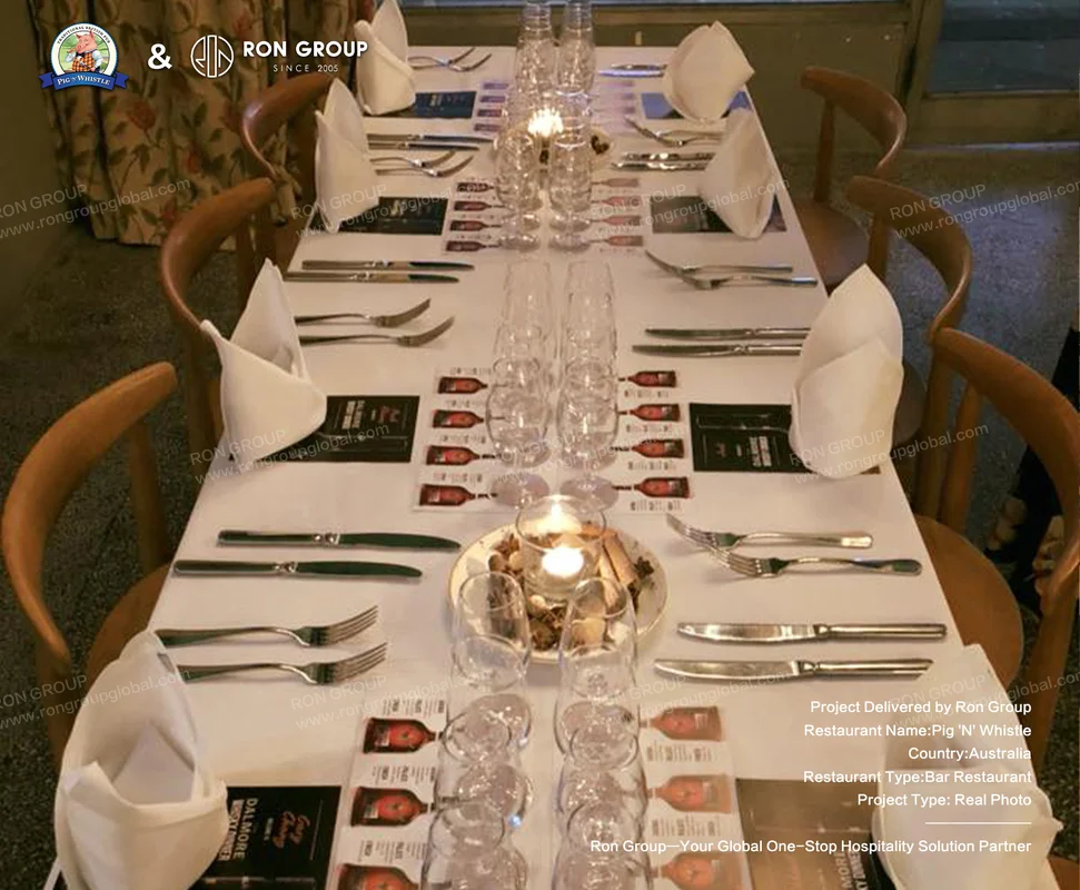 Formal dining table set for eight with white linen and candles