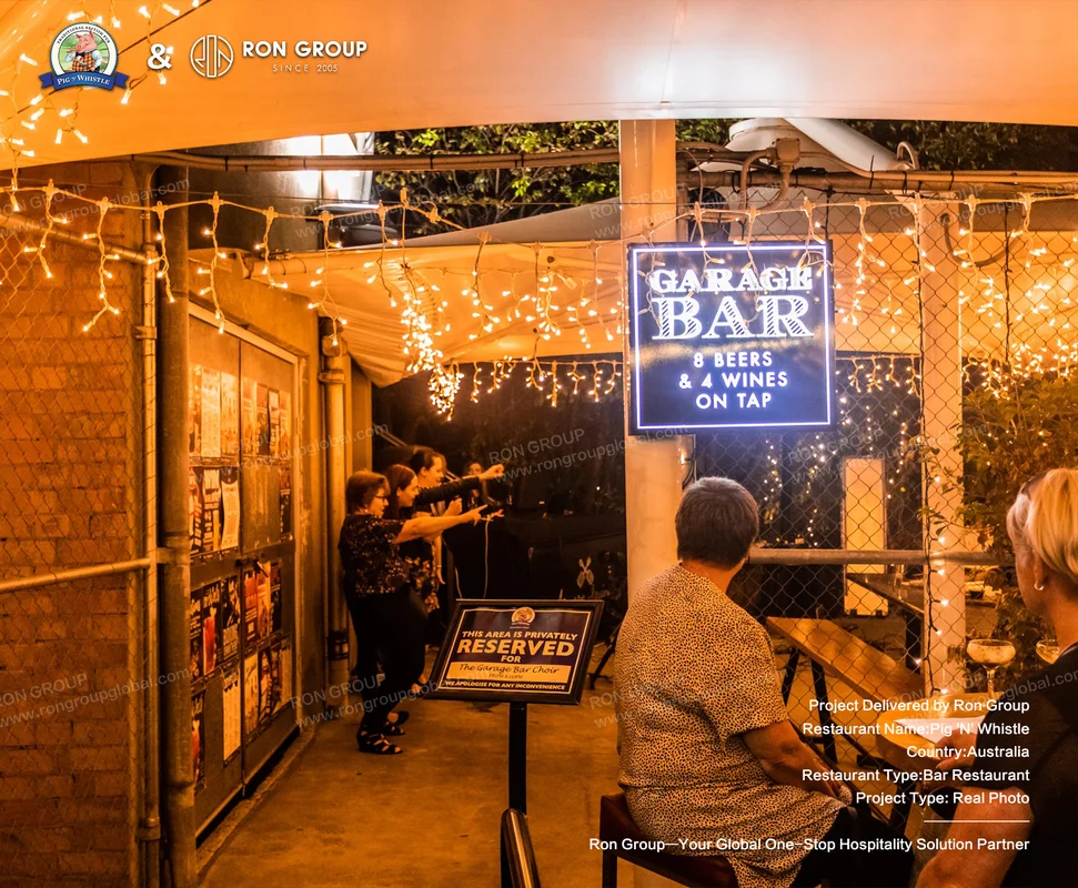 Garage bar with neon sign and string lights