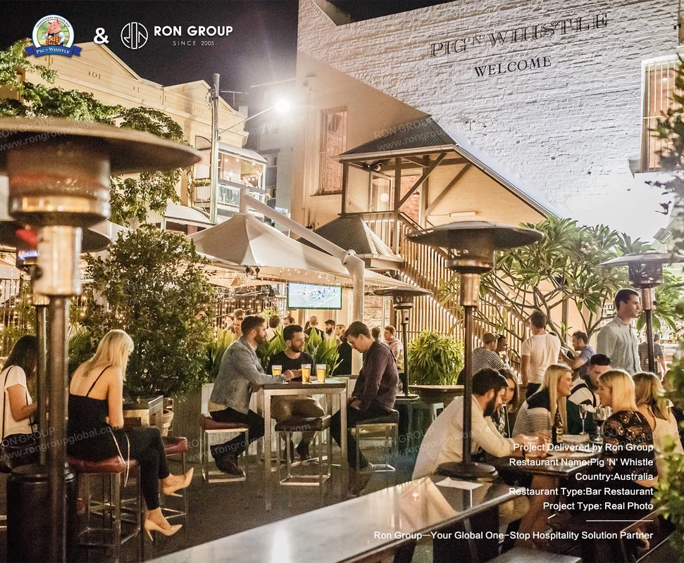 Outdoor bar at night with warm lighting and welcome sign