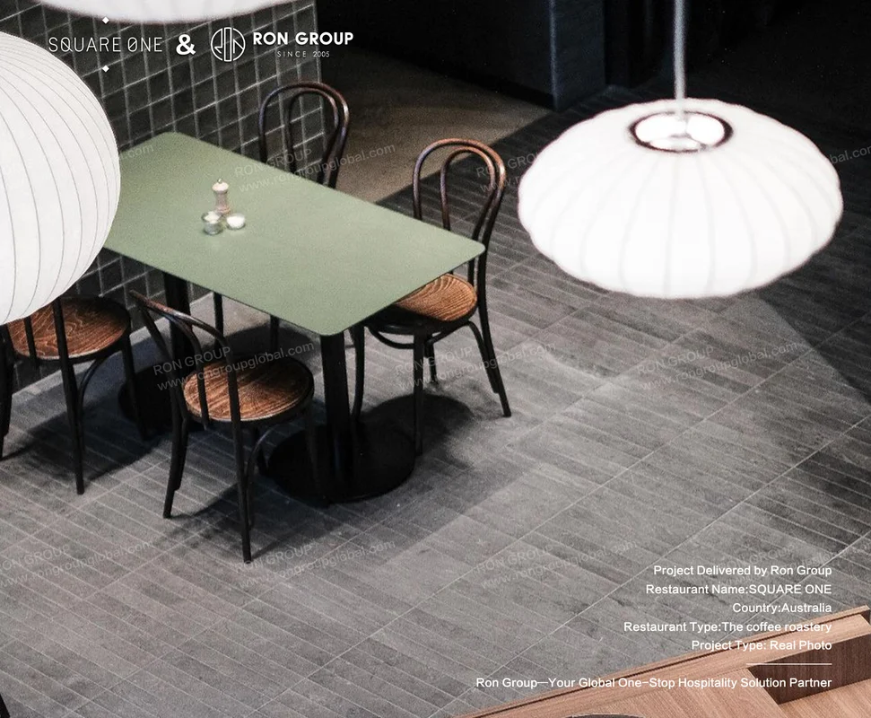SQUARE ONE green table with black cafe chairs