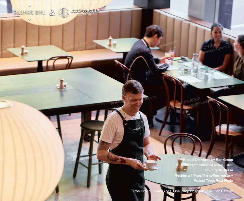 SQUARE ONE service scene with timber chairs and green tables