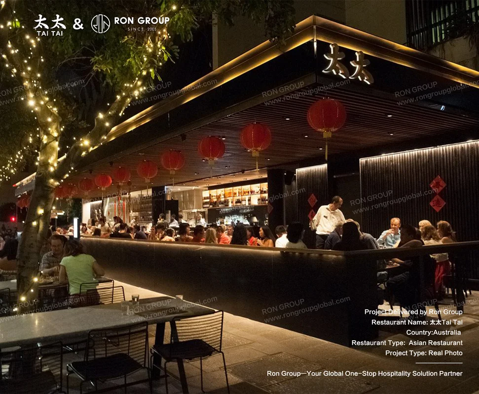 Night-time facade with red lanterns and illuminated signage