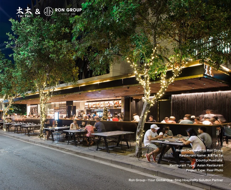 Tai Tai outdoor dining at night with fairy lights and modern furniture