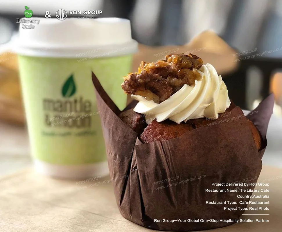 The Library Cafe cupcake with cream topping and takeaway cup