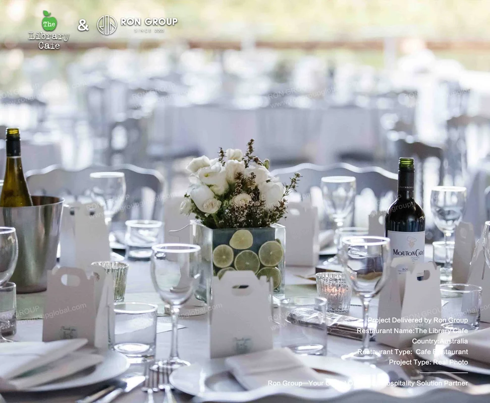 The Library Cafe elegant outdoor dining table setting with white flowers and glassware