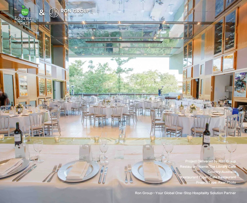 The Library Cafe spacious modern dining hall with glass ceiling and silver chairs