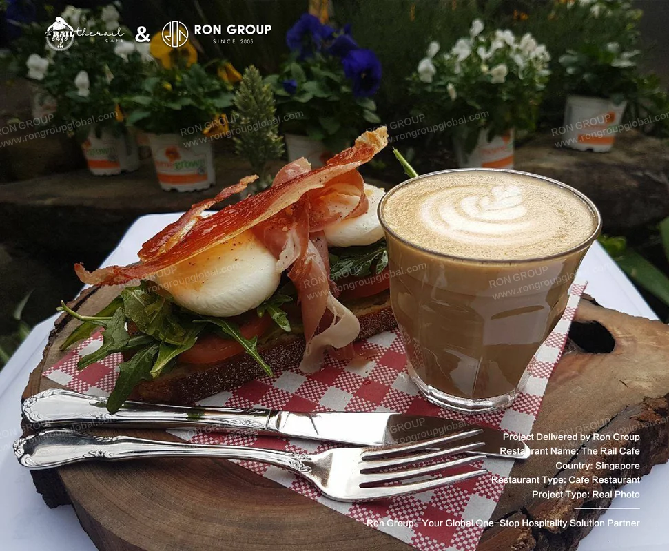 The Rail Cafe breakfast sandwich and latte on cafe table