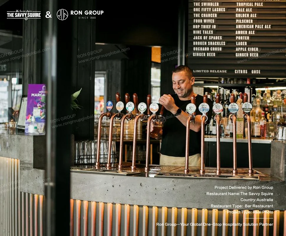 Bartender pouring craft beer at the copper tap bar