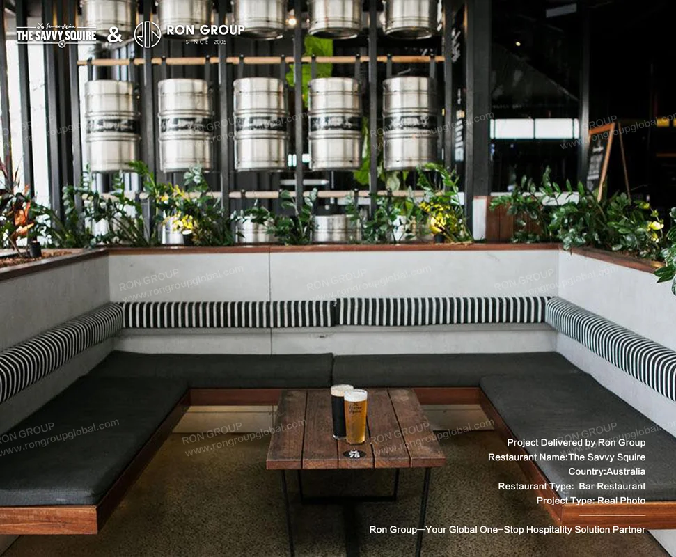 Corner booth with striped upholstery and beer keg backdrop