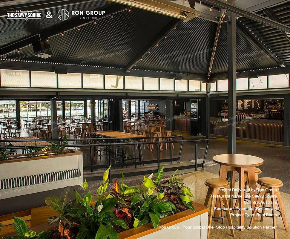 Industrial-style dining space with corrugated metal ceiling and string lights