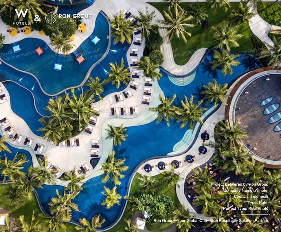 W Bali Seminyak aerial view of resort pool with palms and lounge chairs
