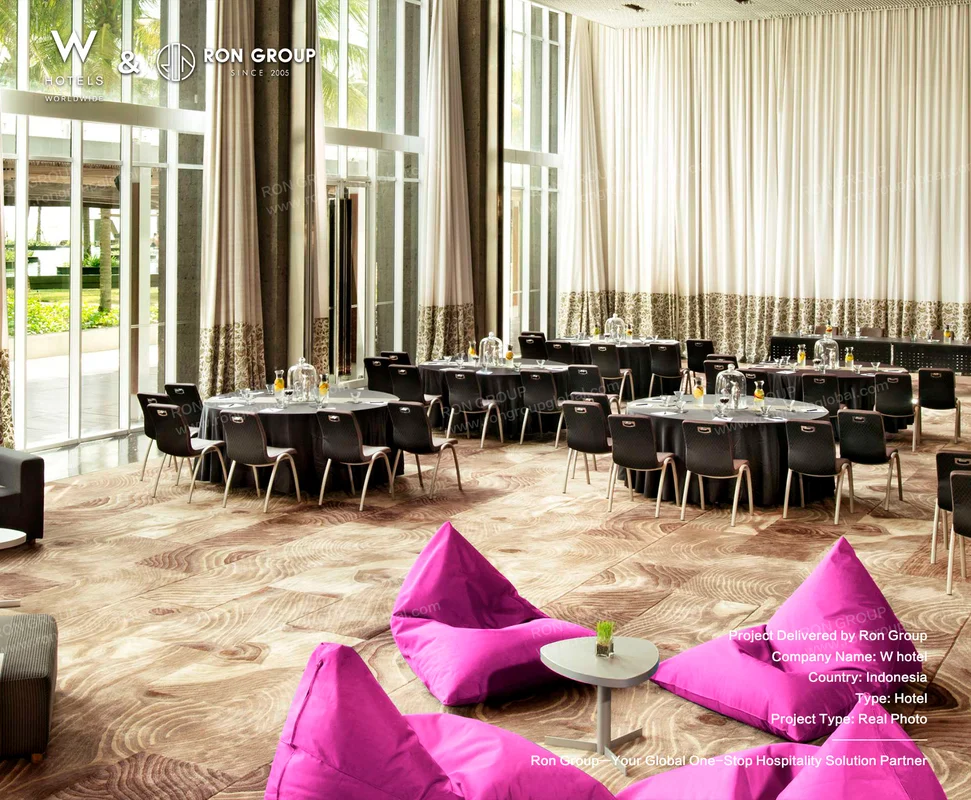 W Bali Seminyak modern indoor event dining area with round tables and pink bean bags