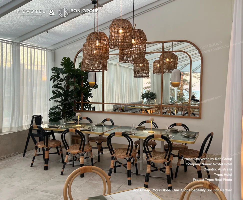 Modern restaurant dining area with rattan chairs and stone tables