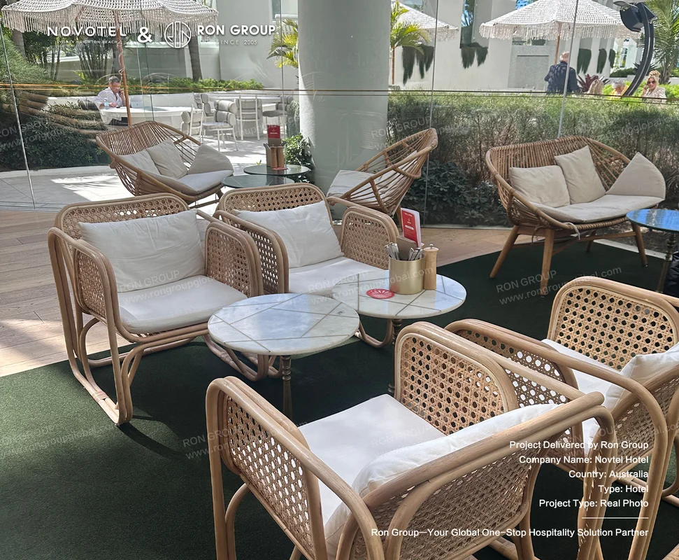Outdoor rattan seating and marble tables for hotel lounge area