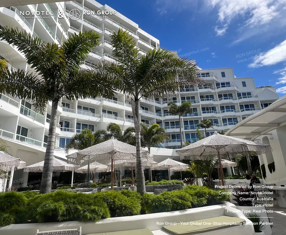 Beachfront hotel exterior with outdoor hospitality furniture