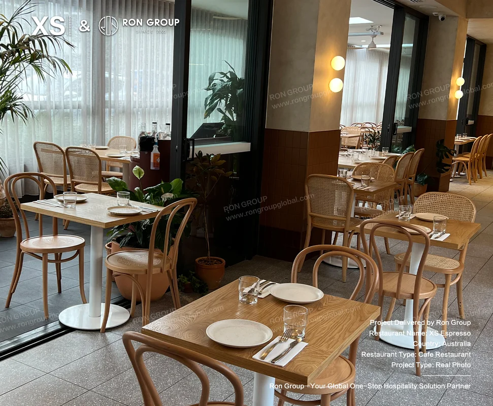 Modern XS Espresso dining area with wood tables and rattan chairs